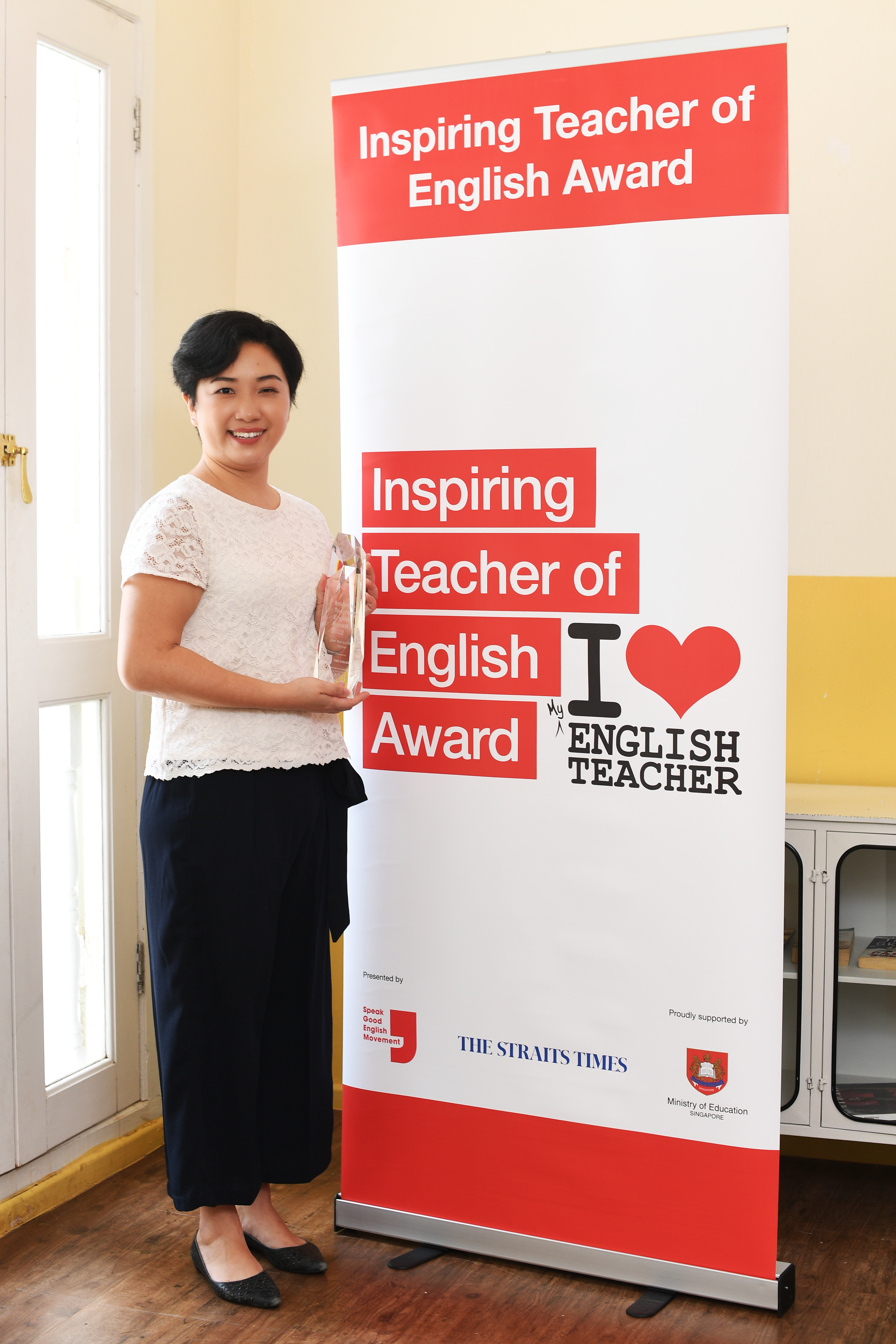 Lim Kai Li Clare standing with trophy