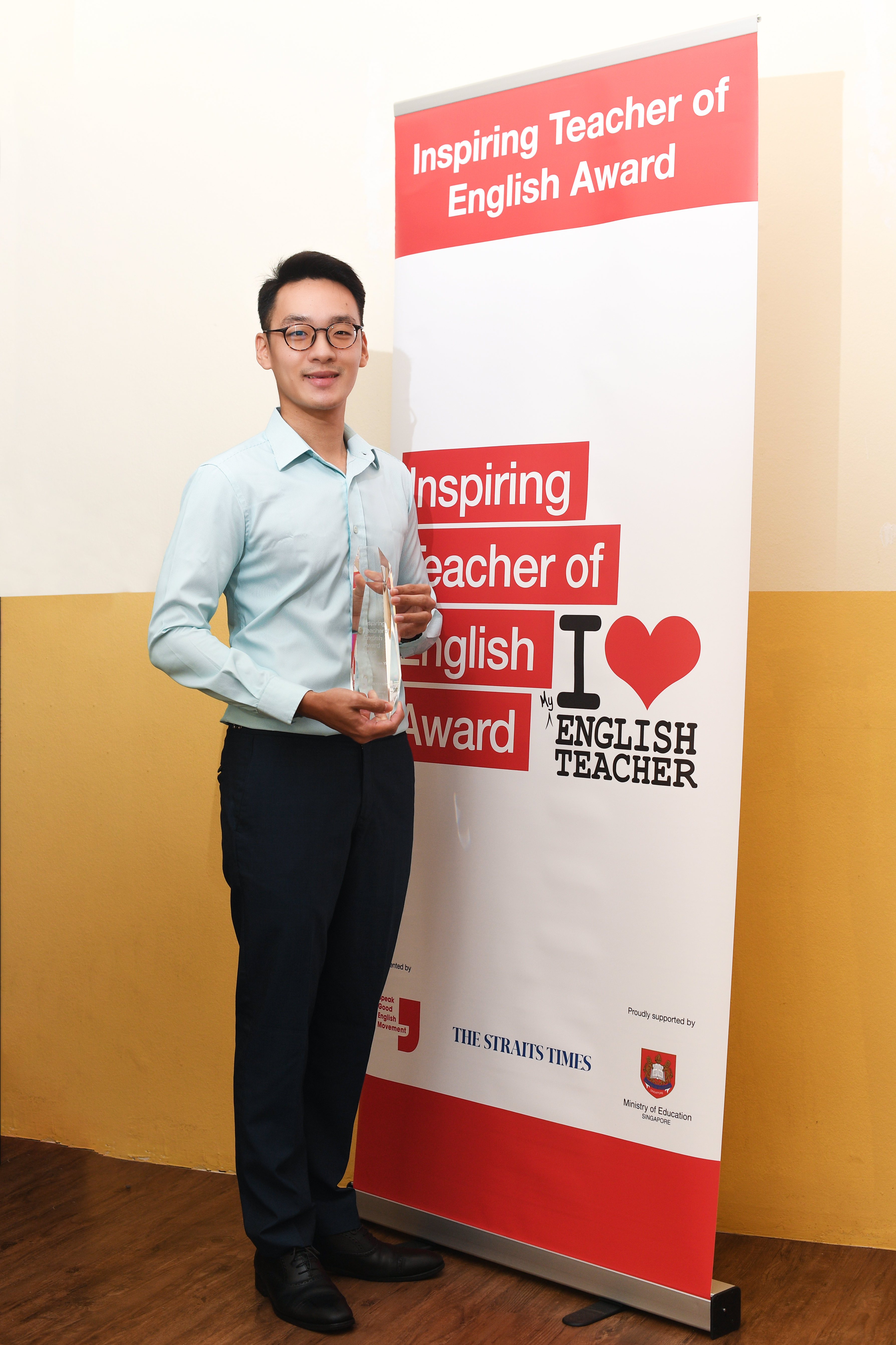 Lim Zhan Yi standing with trophy