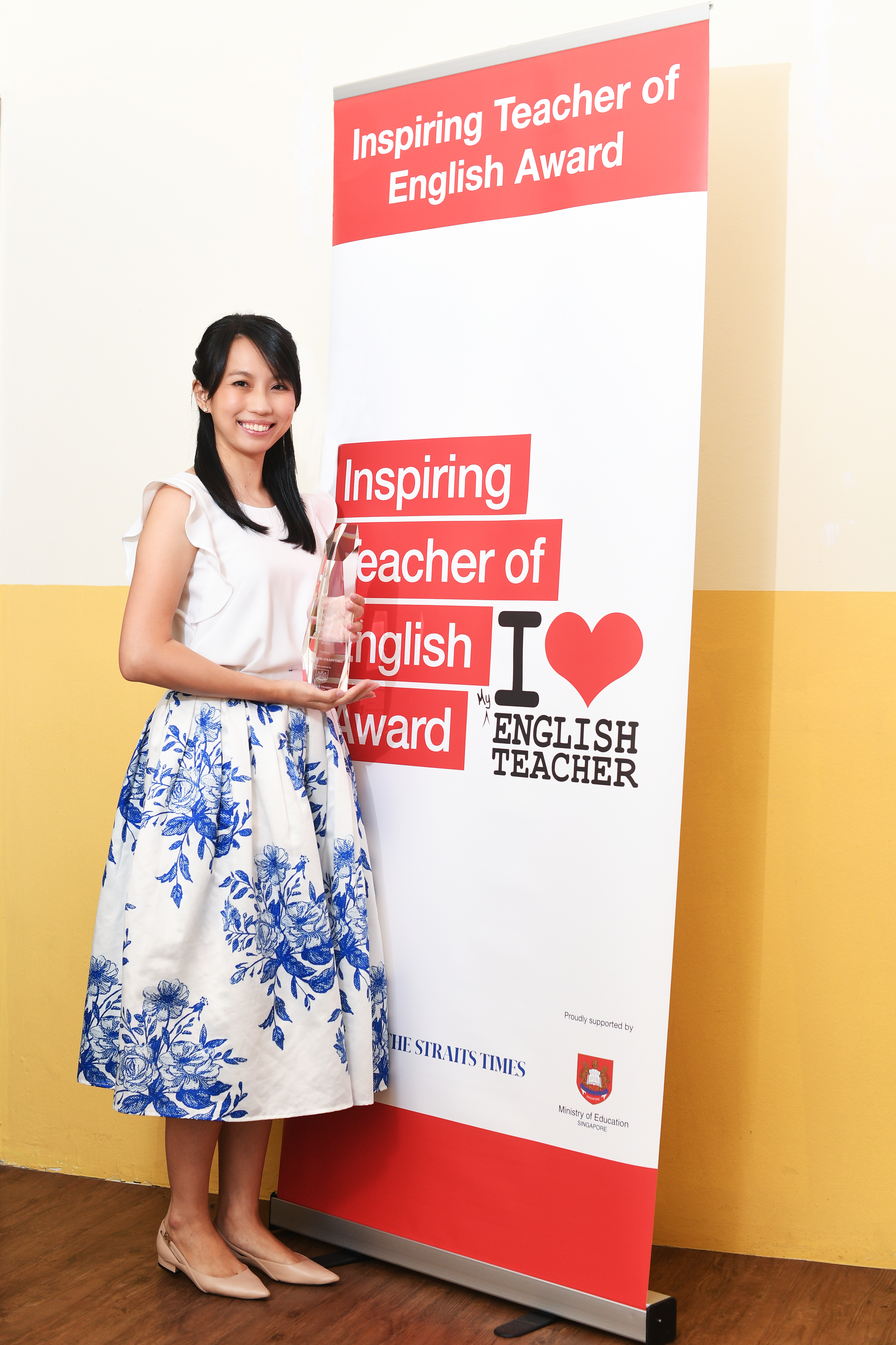 Heng Jing Hui Melody standing with trophy