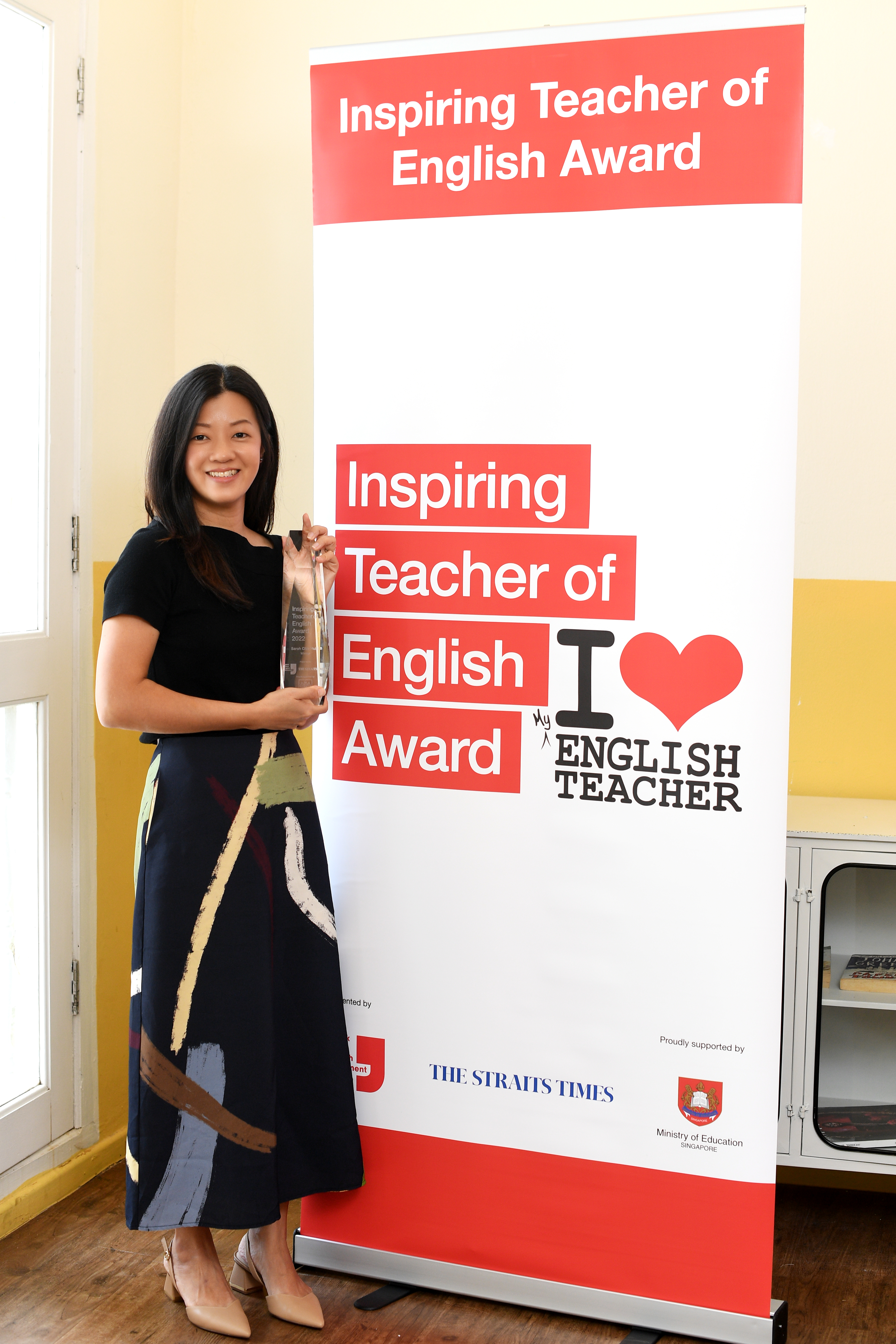 Sarah Chia Hui E standing with trophy